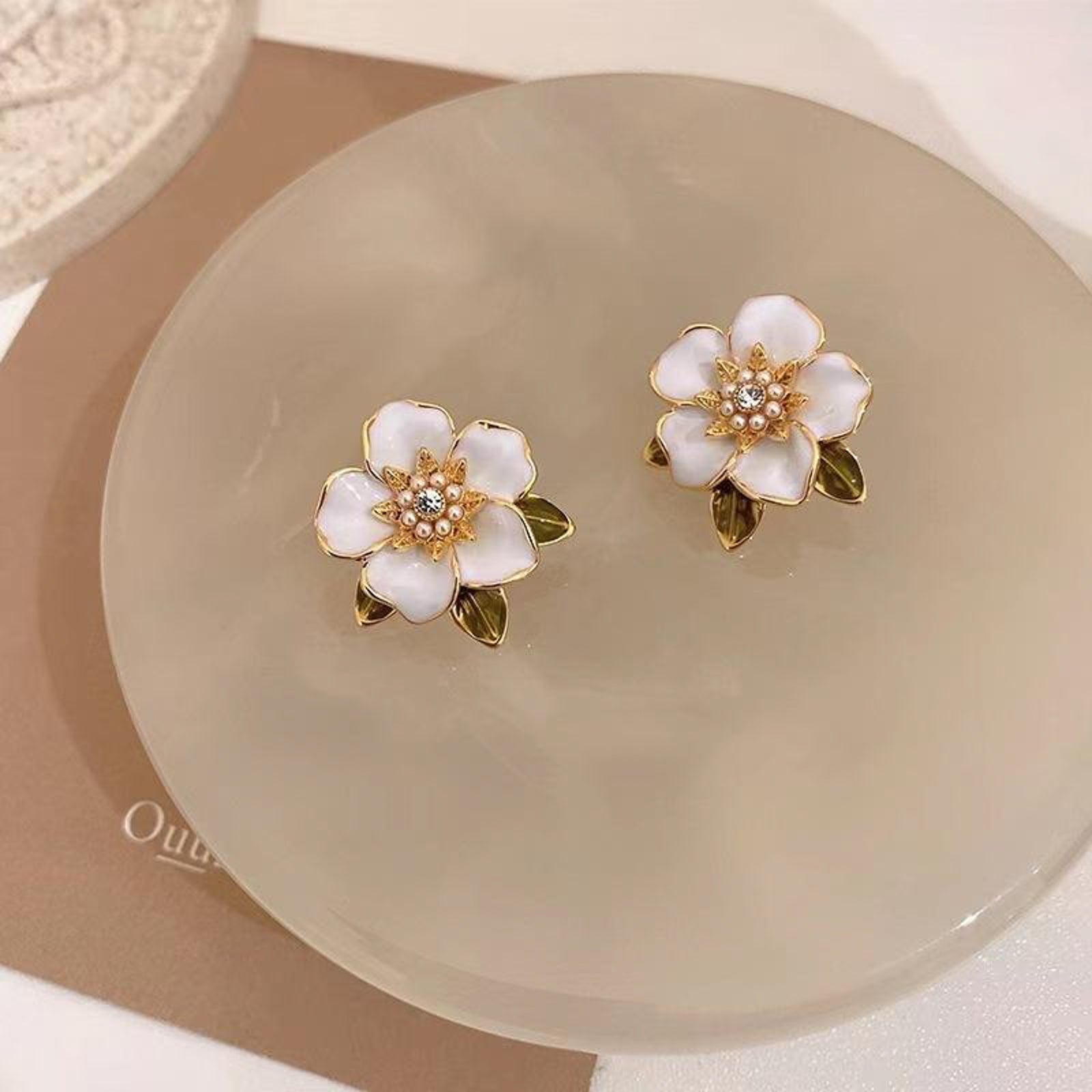 Elegant White Enamel Flower Stud Earrings – Gold-Toned Floral Statement Jewelry with Crystal Center and Green Leaf Accents